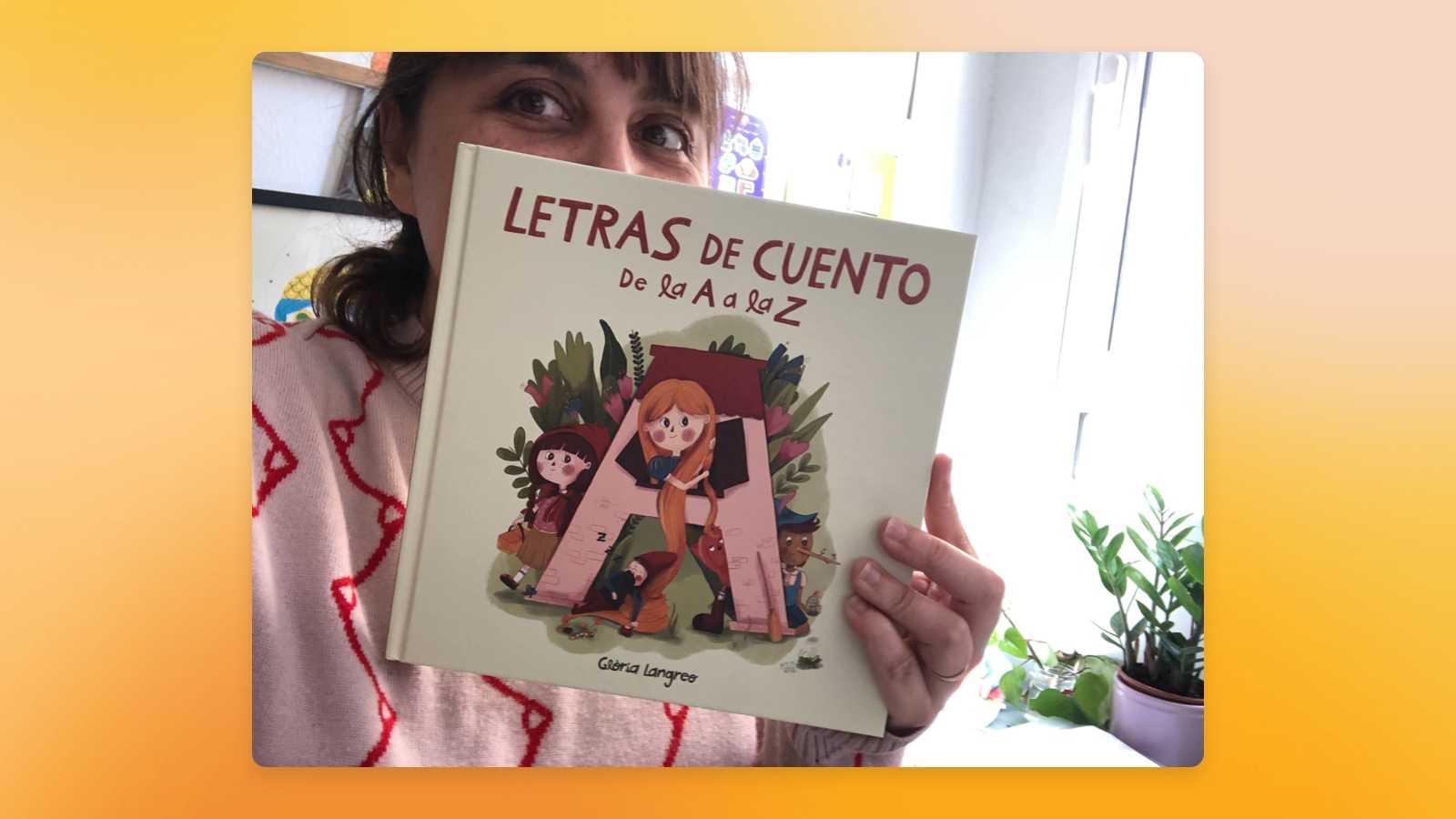 Image showing Glòria Langreo holding the childrens book she illustrated.