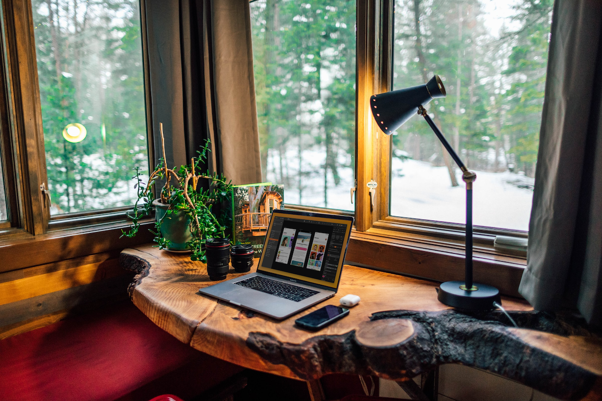 Image showing a cozy office with a wooden desk and rainy environment.